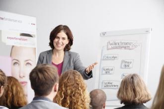 
		Trainer speaks in front of an audience
	